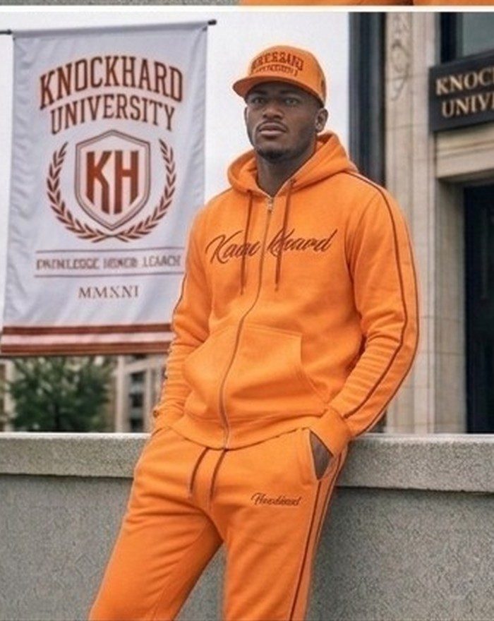 Model in the Solar orange Knockhard University full tracksuit and cap outside the campus hall